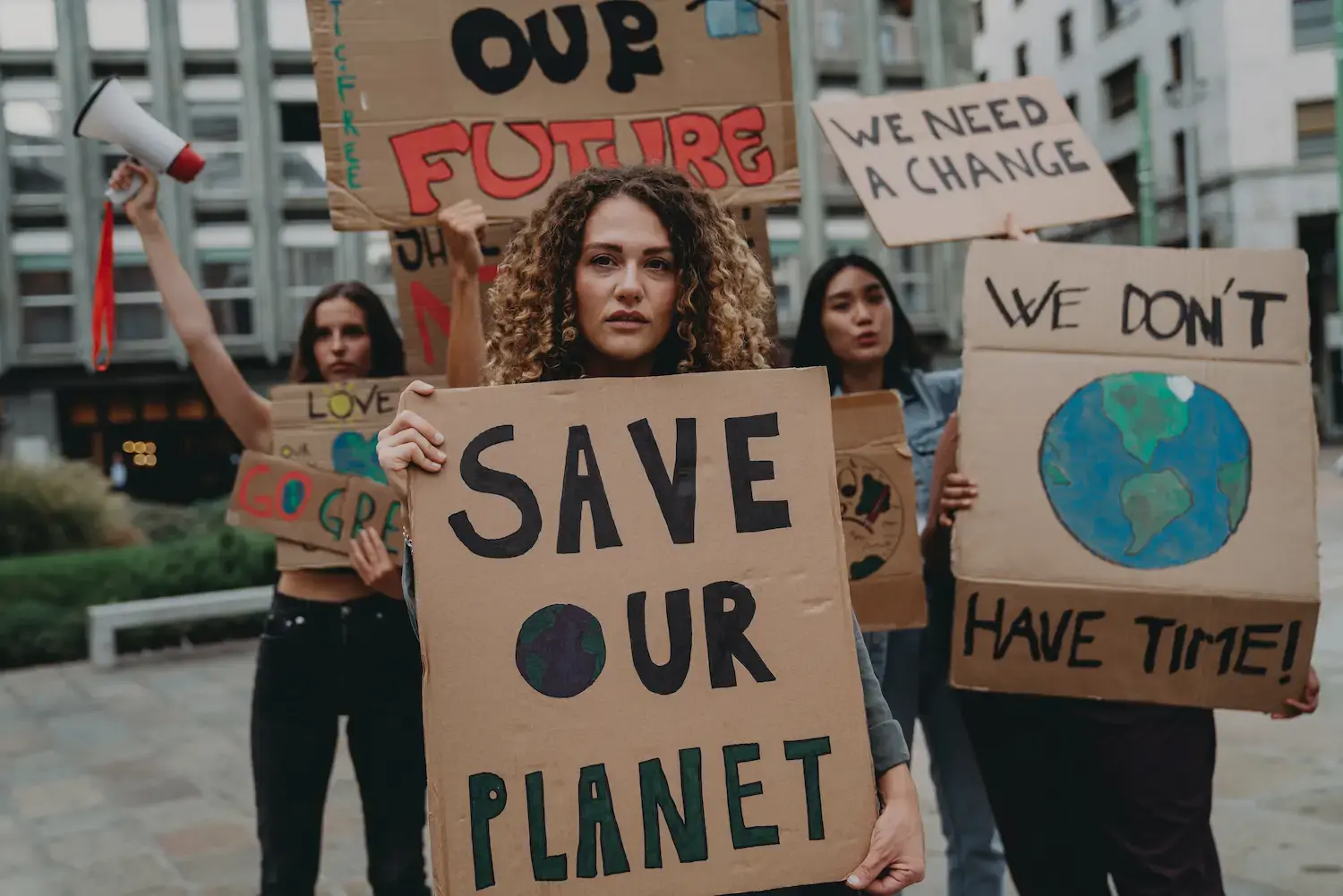 Activists with signs urging to save our planet.
