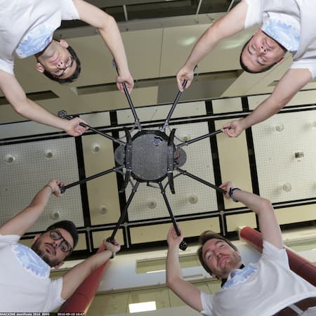 Four AquaEntrepreneur members in matching t-shirts holding up a drone-like device, symbolizing innovation, technology, and entrepreneurial solutions for water-related challenges. Four AquaEntrepreneur members in matching t-shirts holding up a drone-like device, symbolizing innovation, technology, and entrepreneurial solutions for water-related challenges.